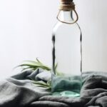 glass water bottle, for mockup, on the table, minimalism scene props, product photography, presented, uhd, image stock no text logo copy caption ar 2:3 style raw v 5.2